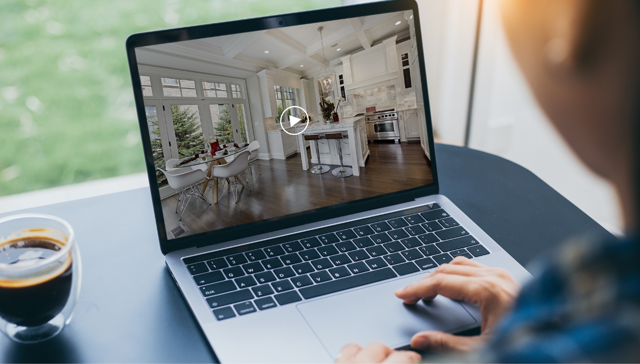Someone viewing a video tour on a laptop computer